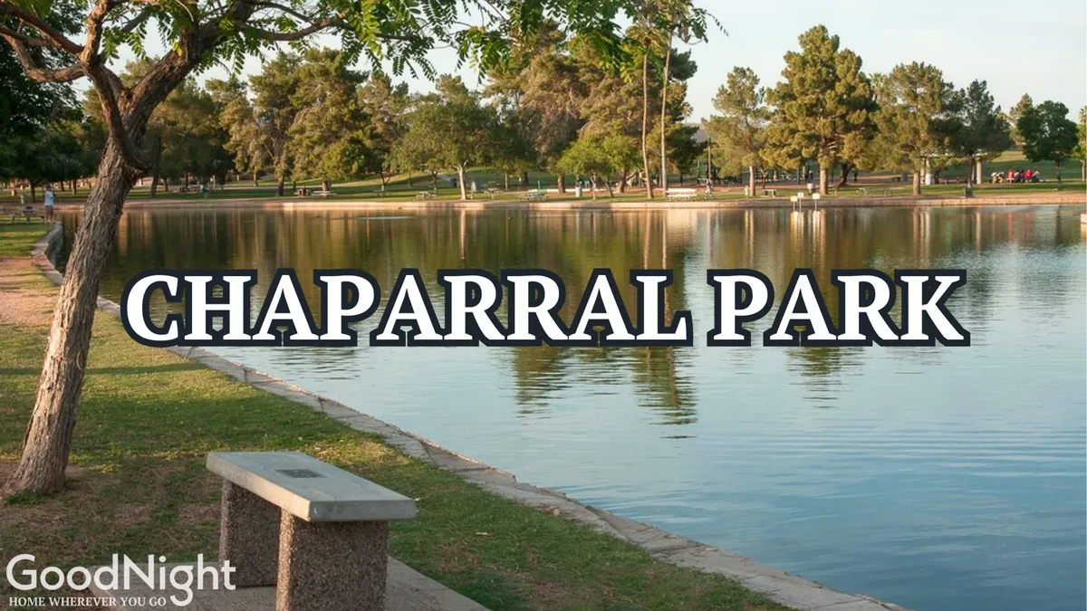 A tranquil park scene with a lake, trees, a park bench, and a winding walking path, evoking the serene, family-oriented atmosphere of Chaparral Park, which is recommended in the section for picnics, playgrounds, and lakeside strolls.